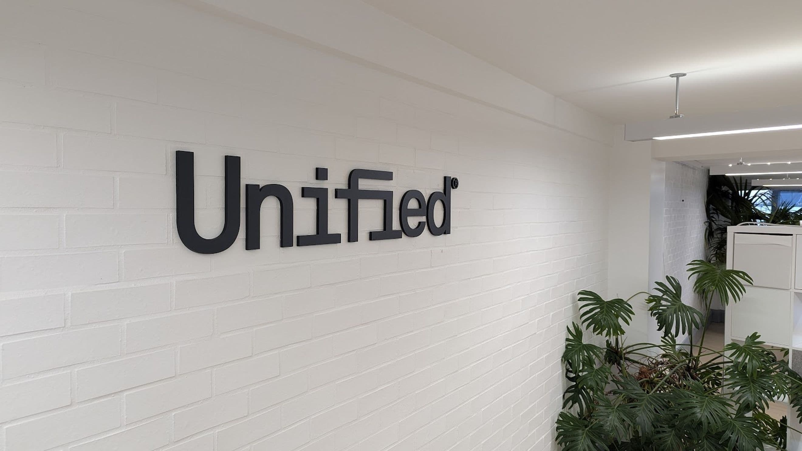 The Unified logo on the wall of our Shopify plus development agency in London.