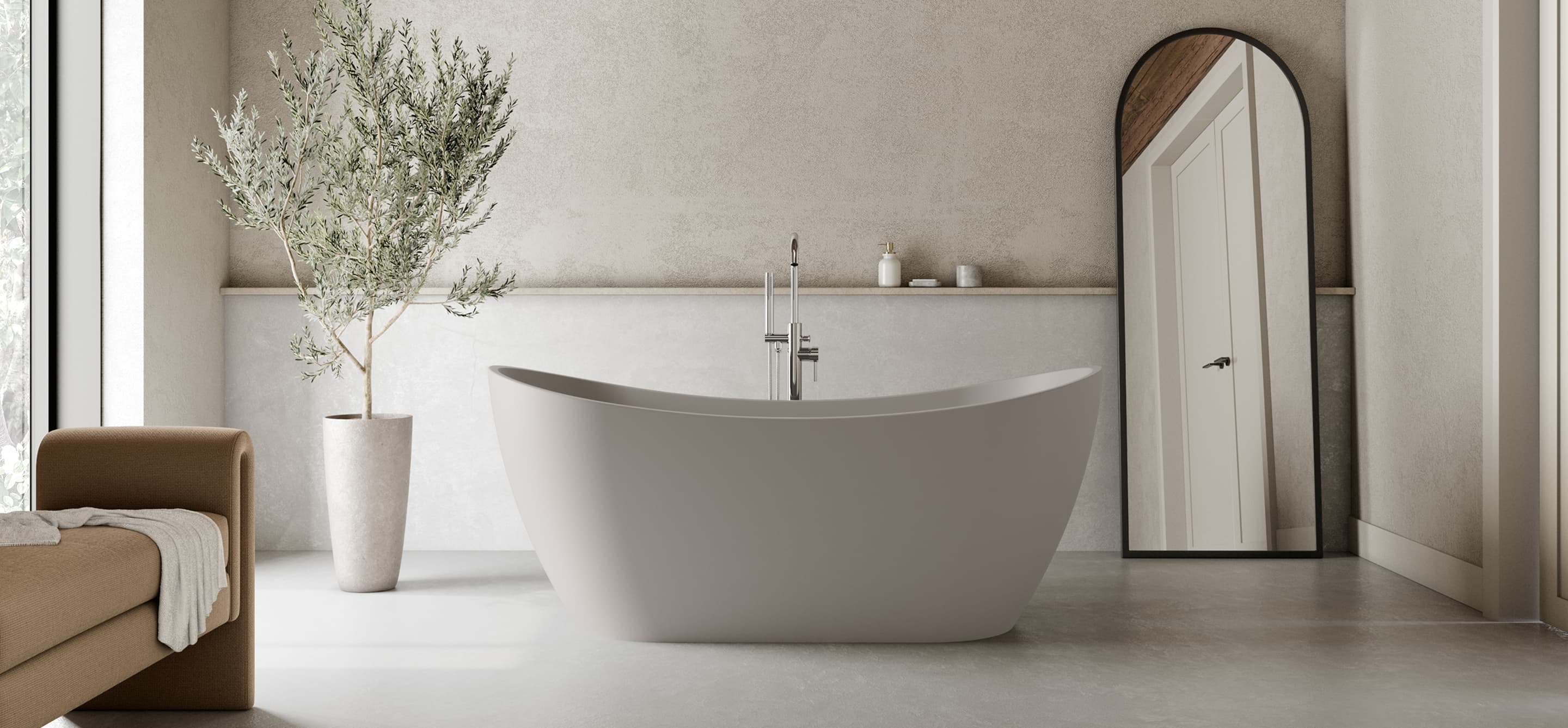 Modern bathroom with a freestanding bathtub, large mirror, potted plant, and minimal decor. Soft natural light fills the space from a nearby window.